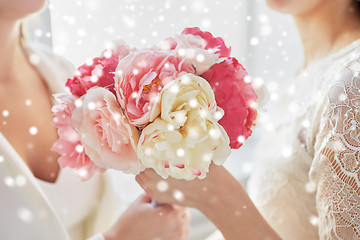 Image showing close up of happy lesbian couple with flowers