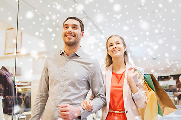 Image showing happy young couple with shopping bags in mall