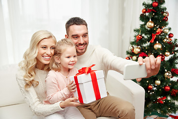 Image showing family taking selfie with smartphone at christmas