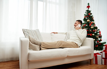 Image showing man calling on smartphone at home for christmas