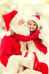 Image showing smiling little girl with santa claus