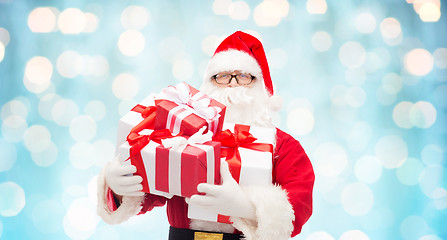 Image showing man in costume of santa claus with gift boxes