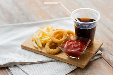 Image showing close up of fast food snacks and drink on table