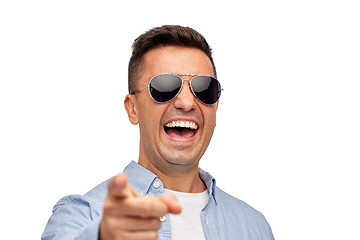 Image showing laughing man in sunglasses pointing finger on you