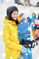 Image showing happy friends in helmets with snowboards