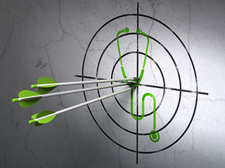 Image showing Medicine concept: arrows in Stethoscope target on wall background