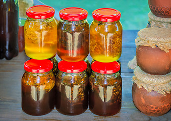 Image showing Different varieties of honey in banks, offered for sale 