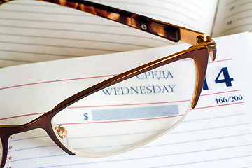 Image showing Glasses and notebook .