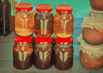 Image showing Different varieties of honey in banks, offered for sale 