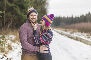 Image showing Young couple hugging in winter forest