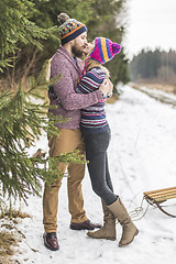 Image showing Young peaople are kissing in winter forest