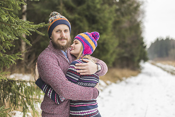 Image showing Young couple hugging in winter forest