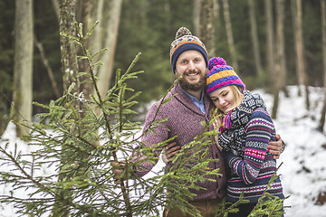 Image showing Young pair with a christmas tree in the forest