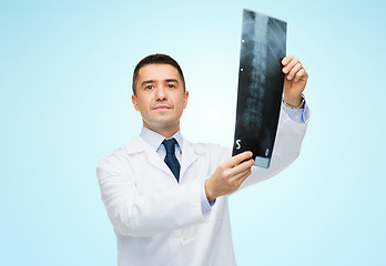 Image showing male doctor in white coat holding x-ray