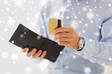 Image showing close up of man holding wallet and credit card