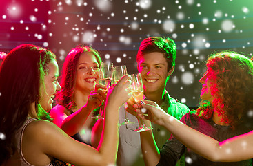 Image showing smiling friends with glasses of champagne in club