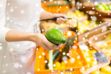 Image showing close up of woman with food basket in market