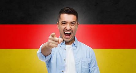 Image showing angry man pointing finger on you over german flag