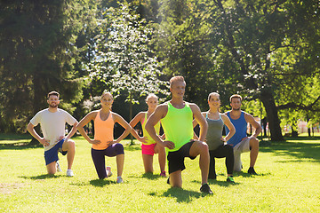 Image showing group of friends or sportsmen exercising outdoors