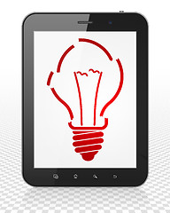 Image showing Finance concept: Tablet Pc Computer with Light Bulb on display