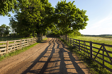 Image showing   Dirt road in the rural area  wooden fence