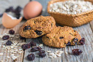 Image showing Homemade oatmeal cookies, eggs and raisins.