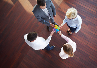 Image showing business people group assembling jigsaw puzzle