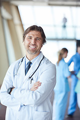 Image showing group of medical staff at hospital, handsome doctor in front of 