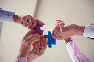 Image showing business people group assembling jigsaw puzzle