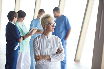 Image showing female doctor with glasses and blonde hairstyle standing in fron