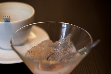 Image showing empty coffee cup and vase out of ice cream