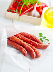 Image showing sausages in paper, vegetables in the box