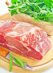 Image showing raw meat and knife on the wooden board