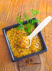 Image showing Mustard in the black bowl on table