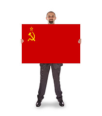 Image showing Smiling businessman holding a big card, flag of the USSR