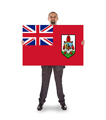 Image showing Smiling businessman holding a big card, flag of Bermuda