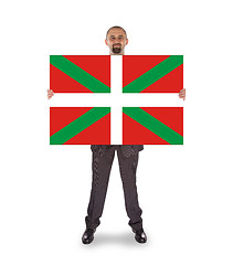 Image showing Smiling businessman holding a big card, flag of Basque Country