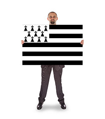 Image showing Smiling businessman holding a big card, flag of Brittany