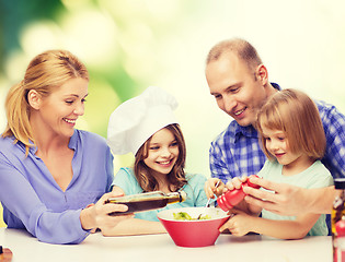 Image showing happy family with two kids eating at home