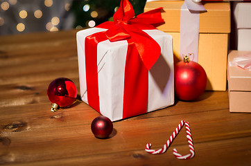 Image showing gifts, candies and christmas balls on wooden board