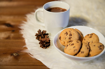 Image showing cups of hot chocolate with cookies on fur rug