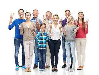 Image showing group of smiling people showing peace hand sign