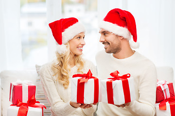 Image showing happy couple at home exchanging christmas gifts