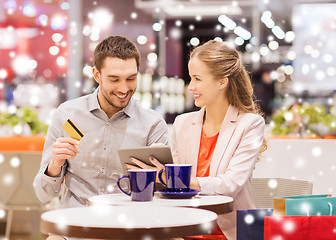 Image showing couple with tablet pc and credit card in mall