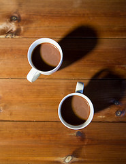 Image showing cups of hot chocolate or cocoa drinks on wood