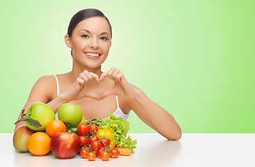 Image showing woman with healthy food showing heart shape sign