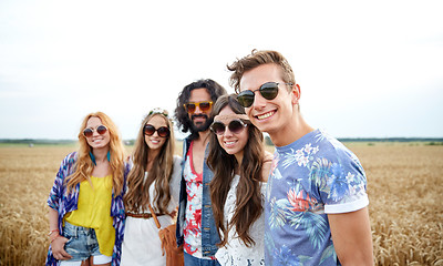 Image showing smiling young hippie friends on cereal field