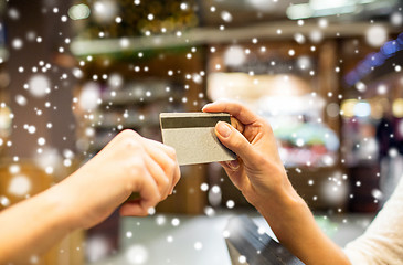 Image showing close up of hands giving credit card in mall