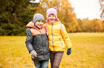 Image showing happy little girl and boy in autumn park