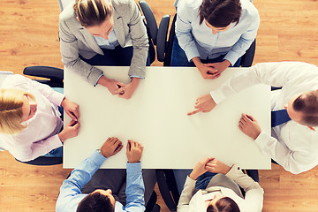 Image showing close up of business team sitting at table